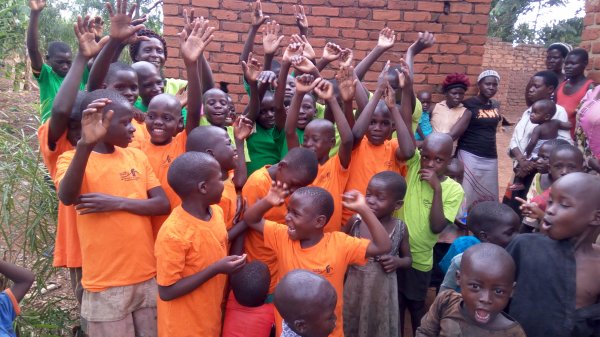 Safo children waving. 