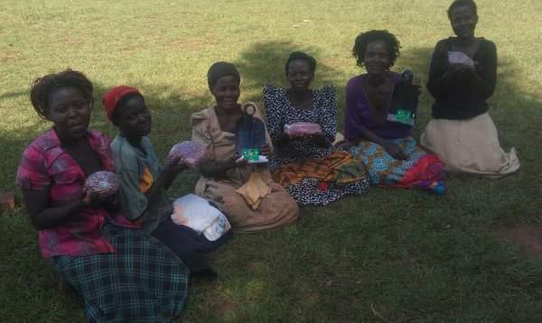 Widows receiving bean seeds and hoes for digging 