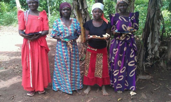 Widows receiving bean seeds and hoes for digging 