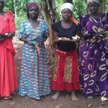 Widows receiving bean seeds and hoes for digging 