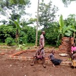 Yuyida, Mpawlo, Shanitah & Chris sitting on New Kitchen wall