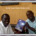 Bishop Joseph Oyuki receiving his Urantia Book from brother Mukono John