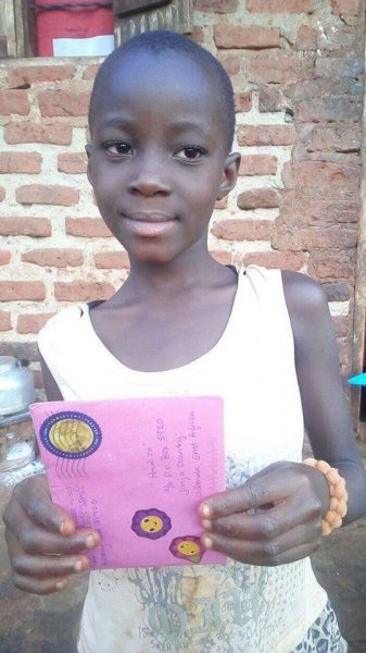 Pictures of two girls receiving letters at Samaritan Foundation Orphanage.