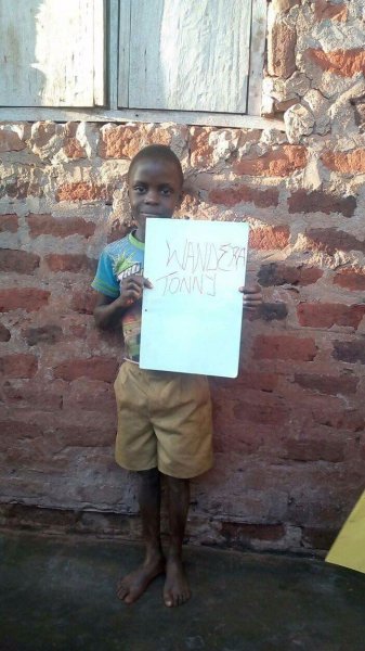 Tony Wandera holding his registration card.