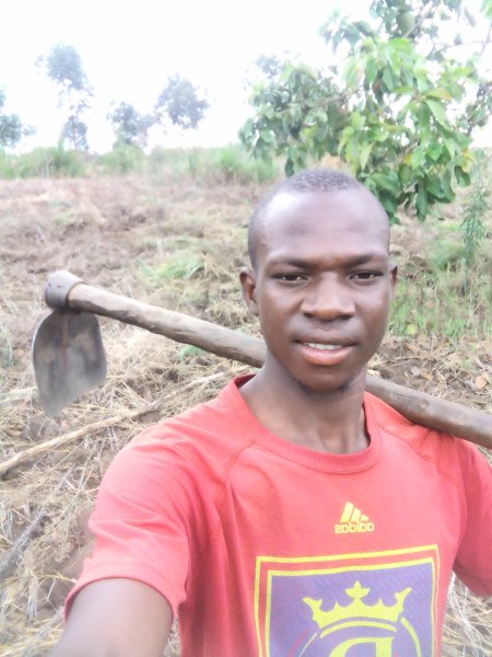 Simon Tumwijukye with mattock is committed to reducing hunger in his region