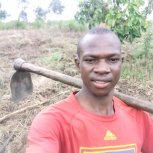 Simon Tumwijukye with mattock is committed to reducing hunger in his region