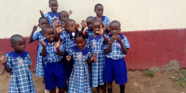 our children posing after recieving uniforms from good samaritian.