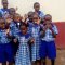 our children posing after recieving uniforms from good samaritian.